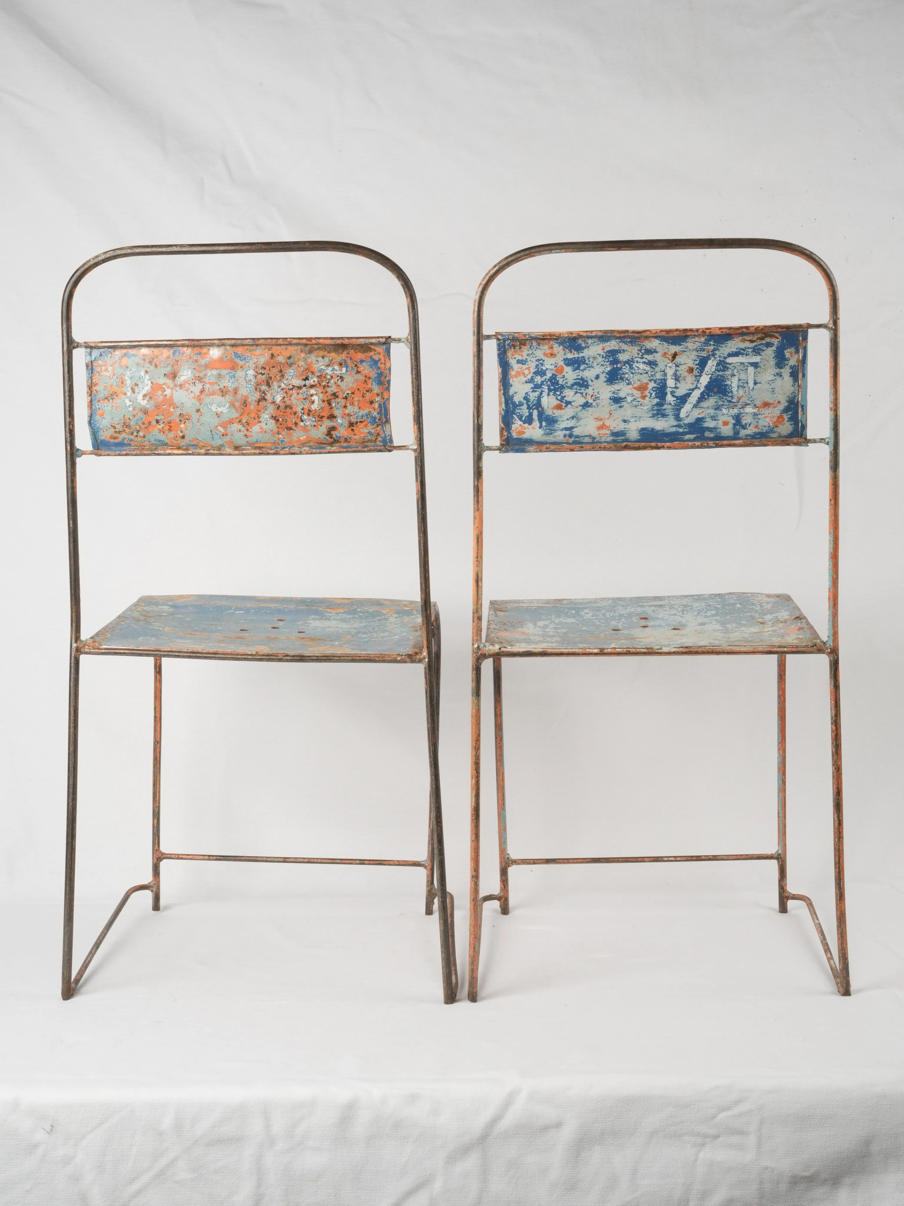 Pair of industrial metal garden chairs w/ blue patina